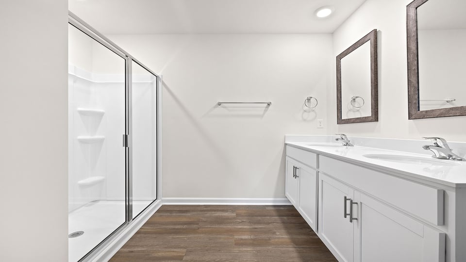 Bathroom with toilet and walk in shower.