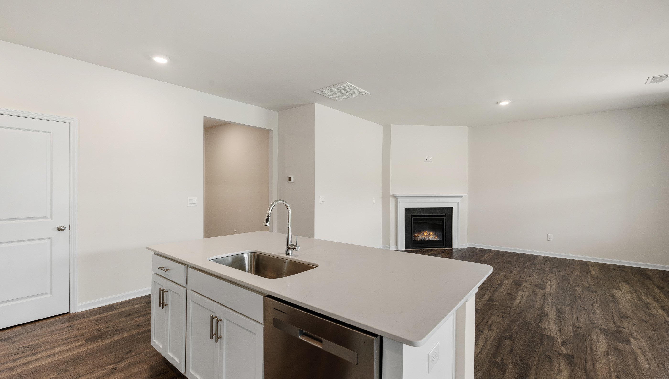 Kitchen and island with stainless steel appliances.