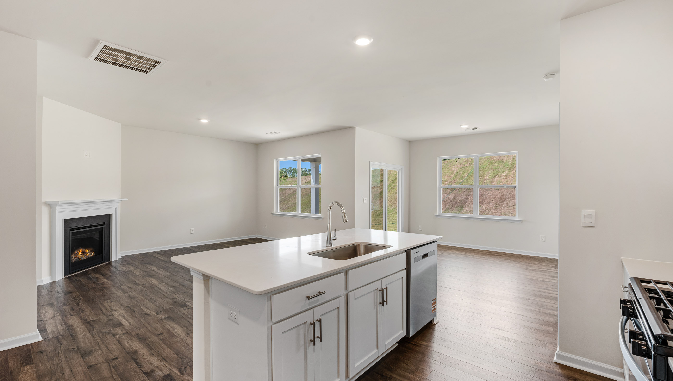 Kitchen and island with stainless steel appliances.
