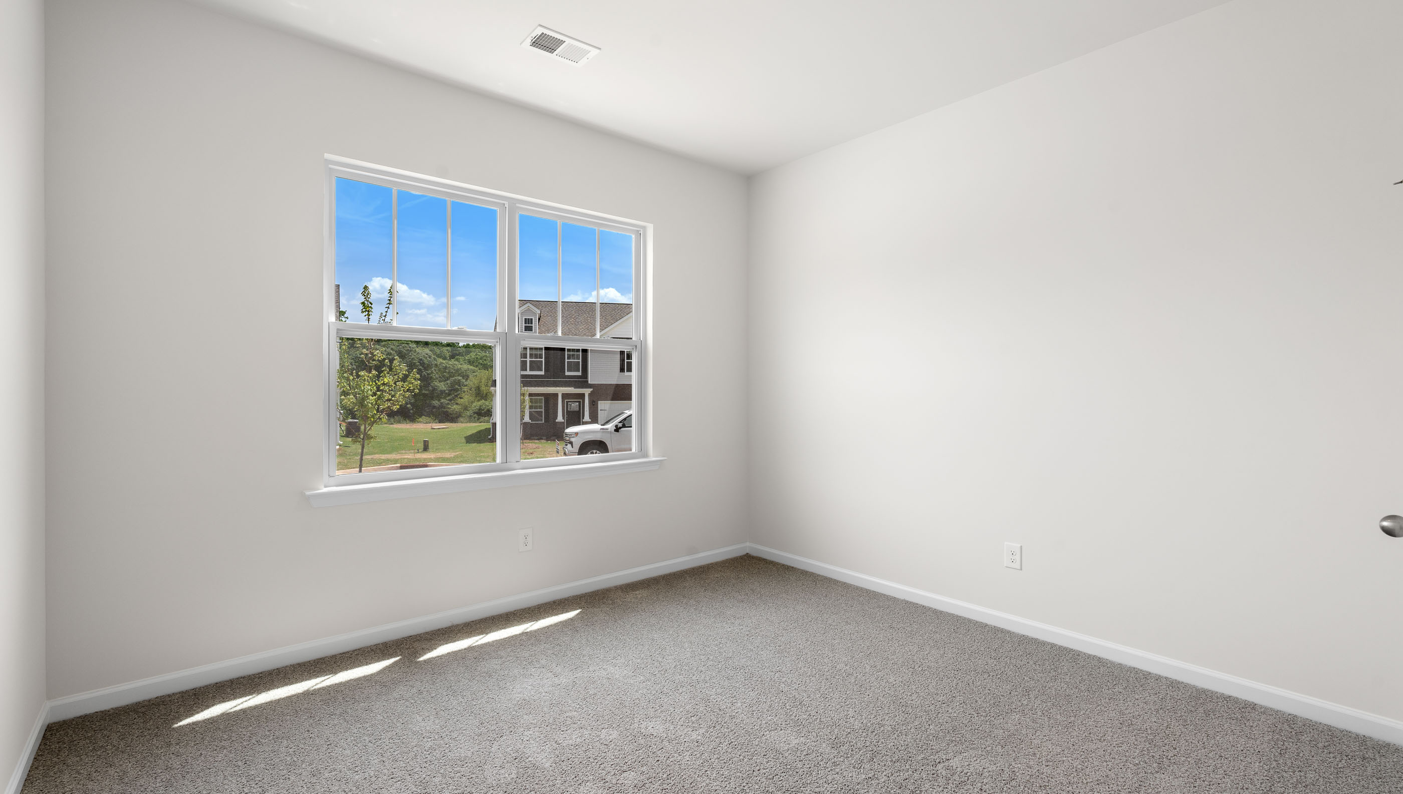Bedroom with carpet and window.