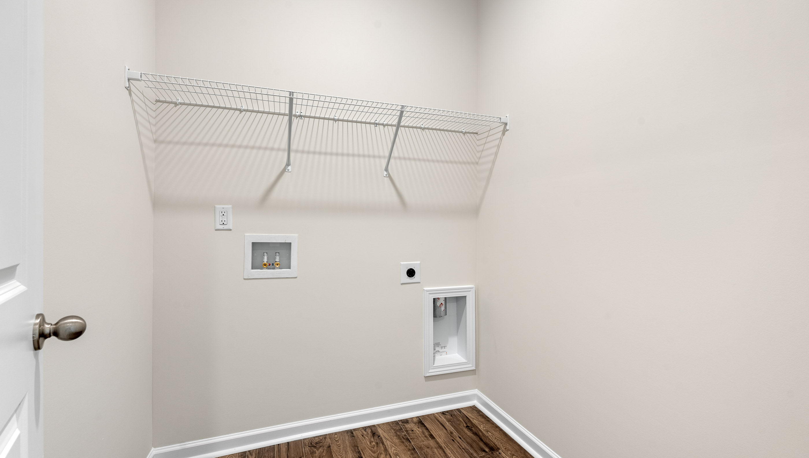 Laundry room with hanging storage racks.