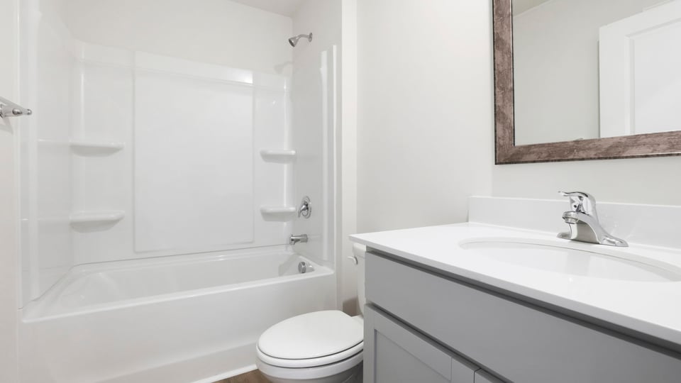 Bathroom with single vanity sink and tub.