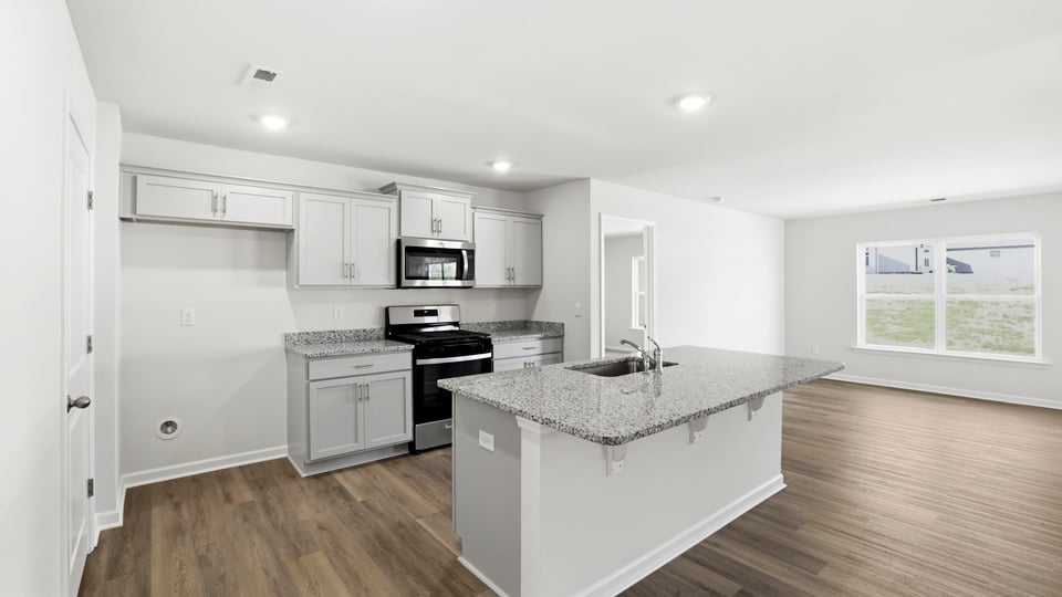 Kitchen with island and quartz counter tops.