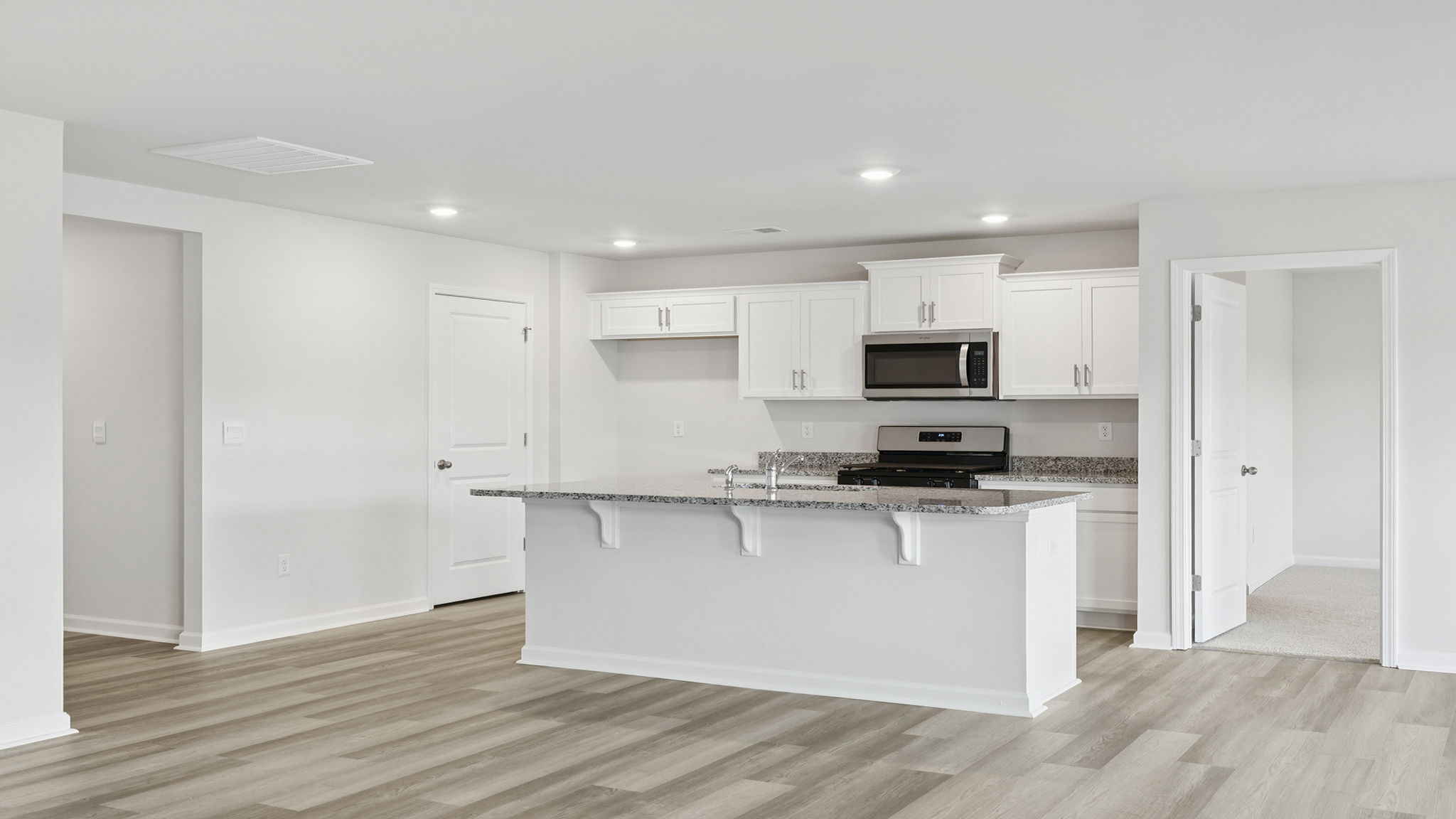 Kitchen with island and recessed lighting.