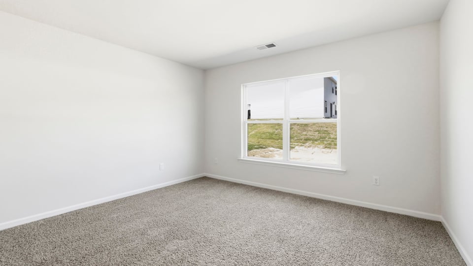 Bedroom with carpet and window.