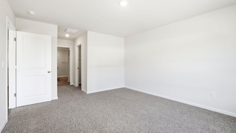 Bedroom with carpet and window.