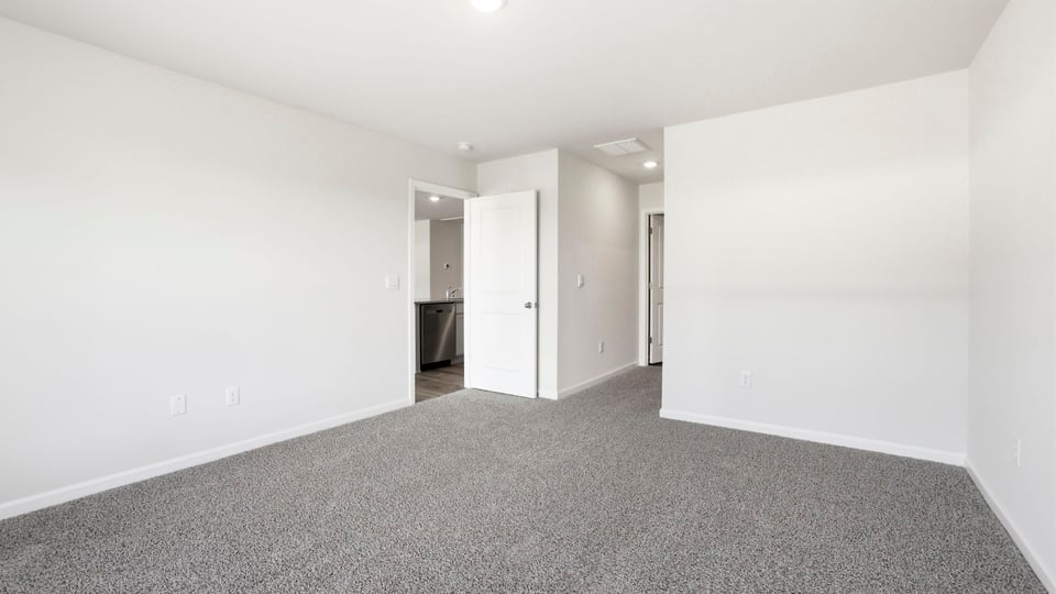 Bedroom with carpet and window.