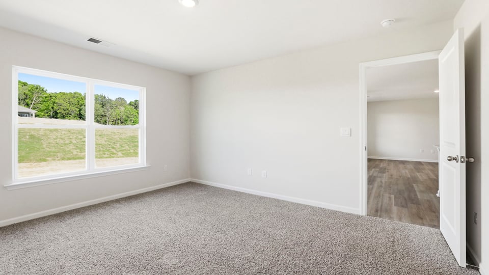 Bedroom with carpet and window.