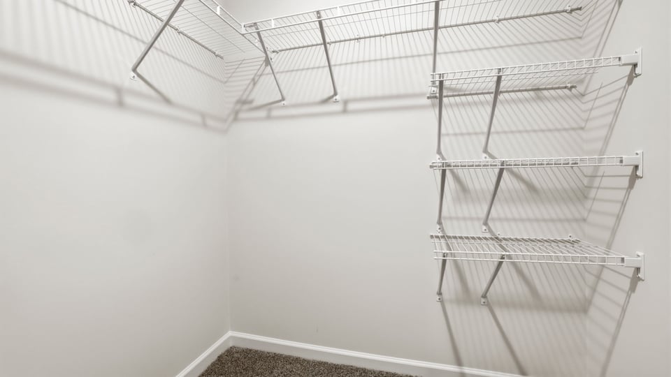 Closet with hanging storage racks.
