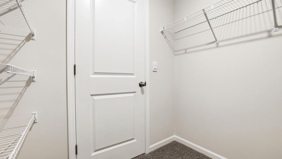 Closet with hanging storage racks.