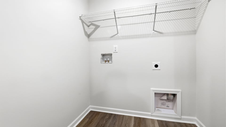 Laundry room with hanging storage racks.