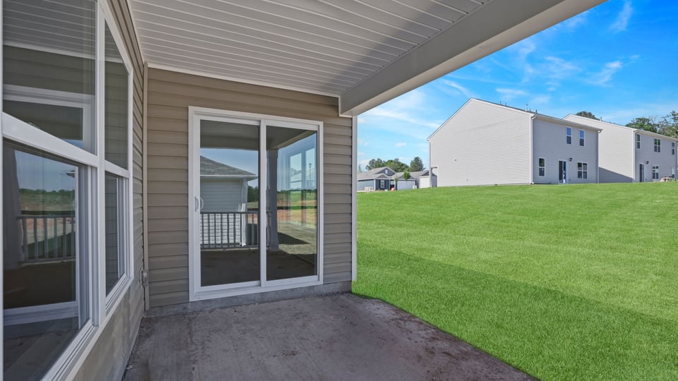 Back exterior of home with patio.