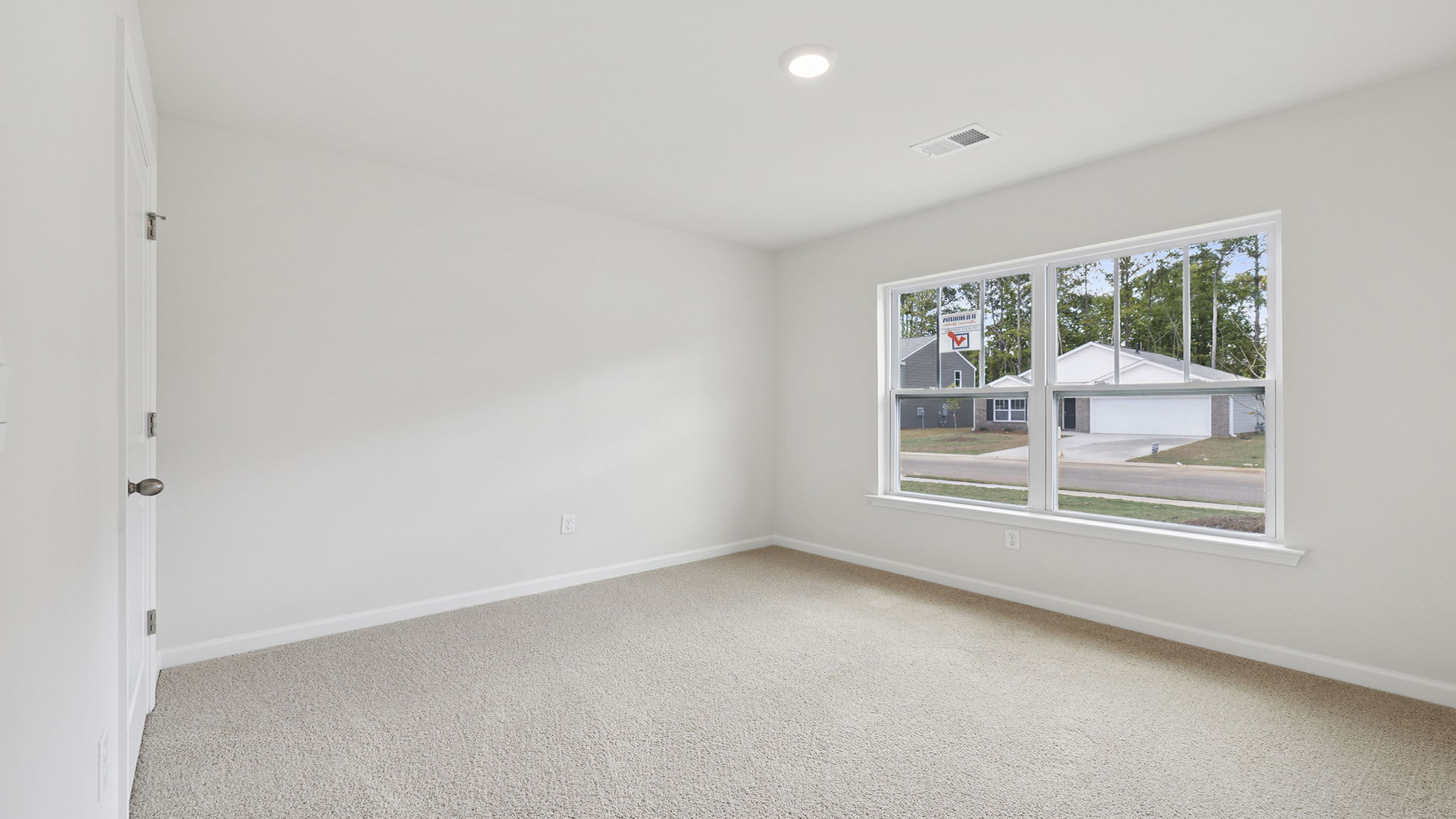 Bedroom with a window and carpet.