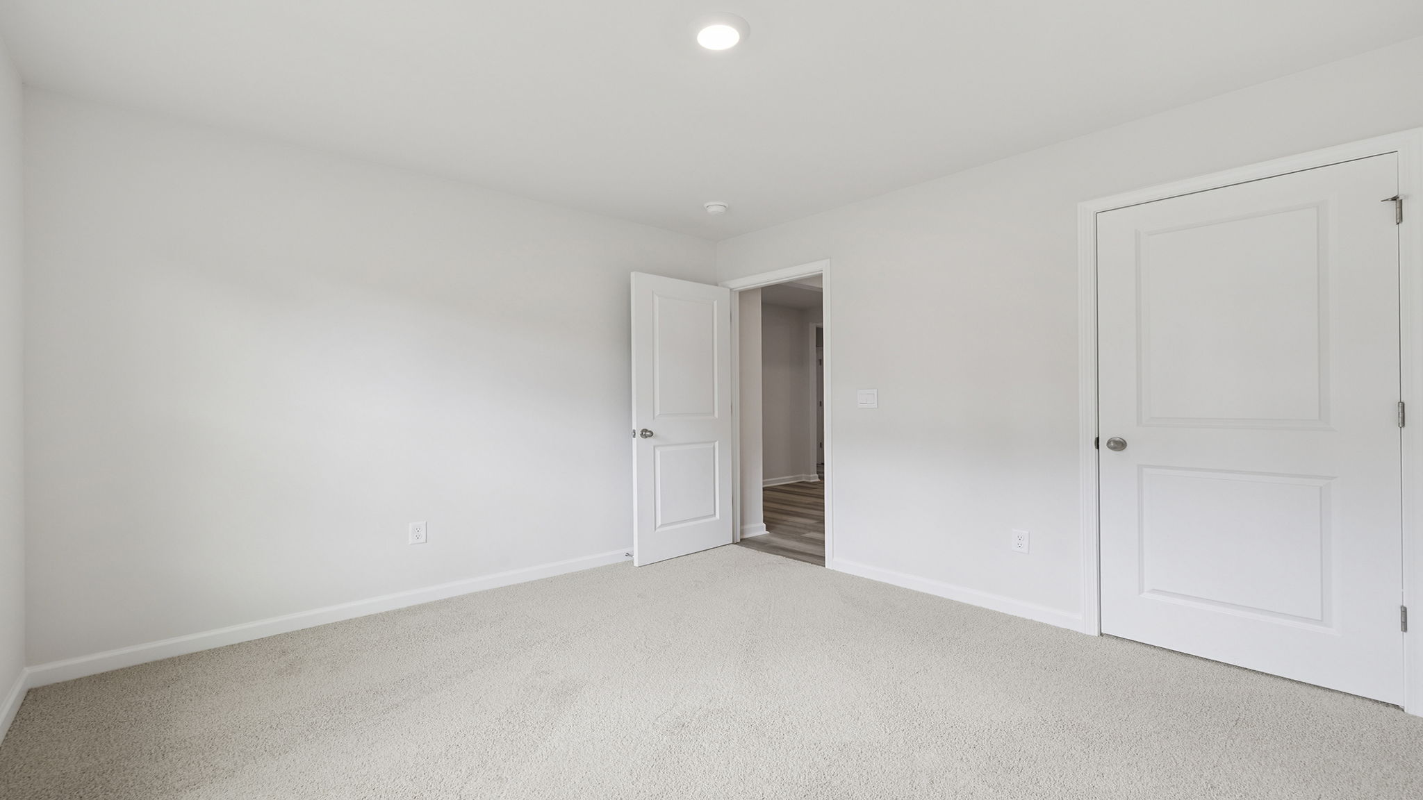 Bedroom with a window and carpet.