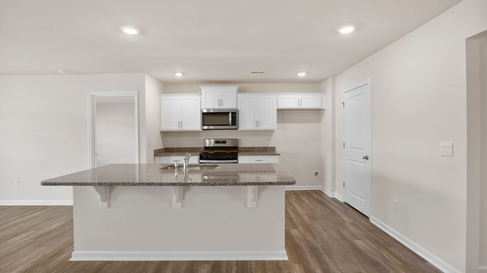 Kitchen with island and cabinets.