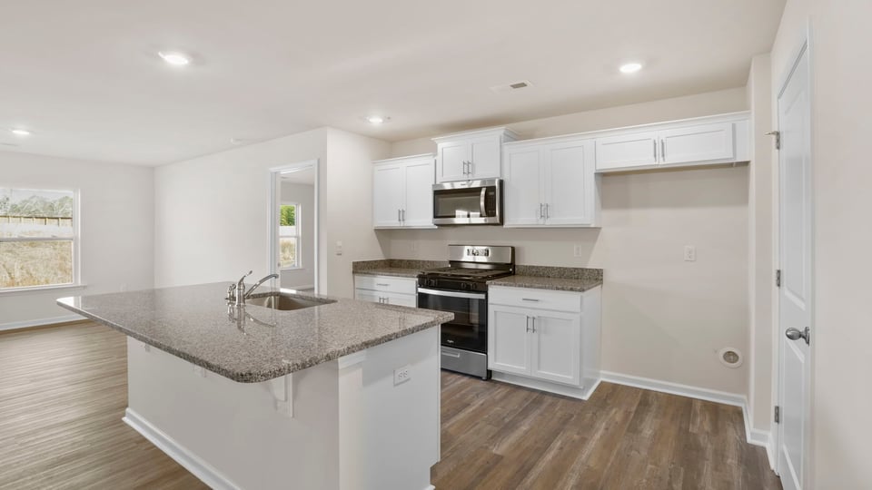 Kitchen with island and cabinets.