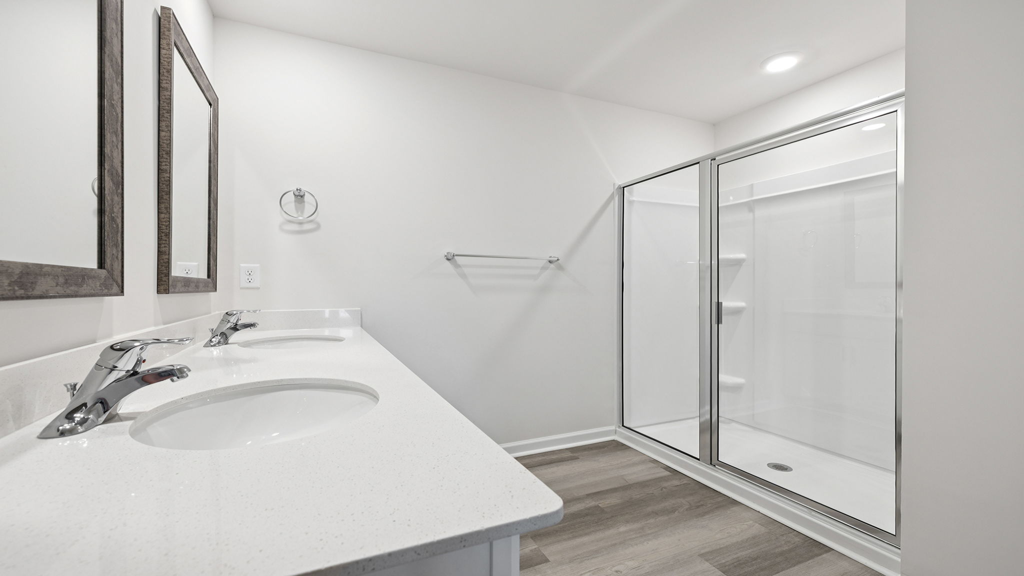 Primary bathroom with dual sink vanity and walk-in shower.