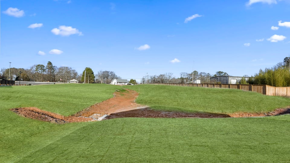 Back exterior with large backyard and patio.