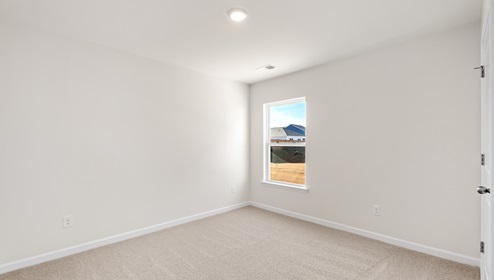 Bedroom with carpet and window.