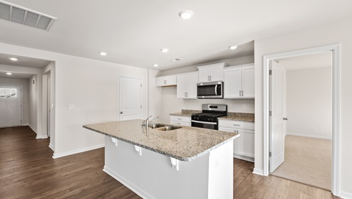 Kitchen and island with granite counter tops.