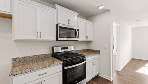 Kitchen and island with granite counter tops.