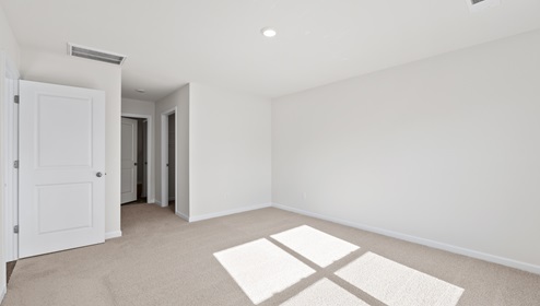 Bedroom with carpet and window.