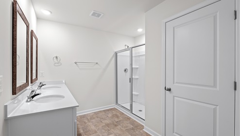 Bathroom with shower and double vanity.