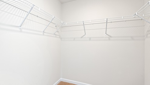 Closet with hanging storage racks.