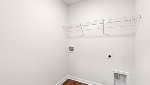 Laundry room with hanging storage racks.