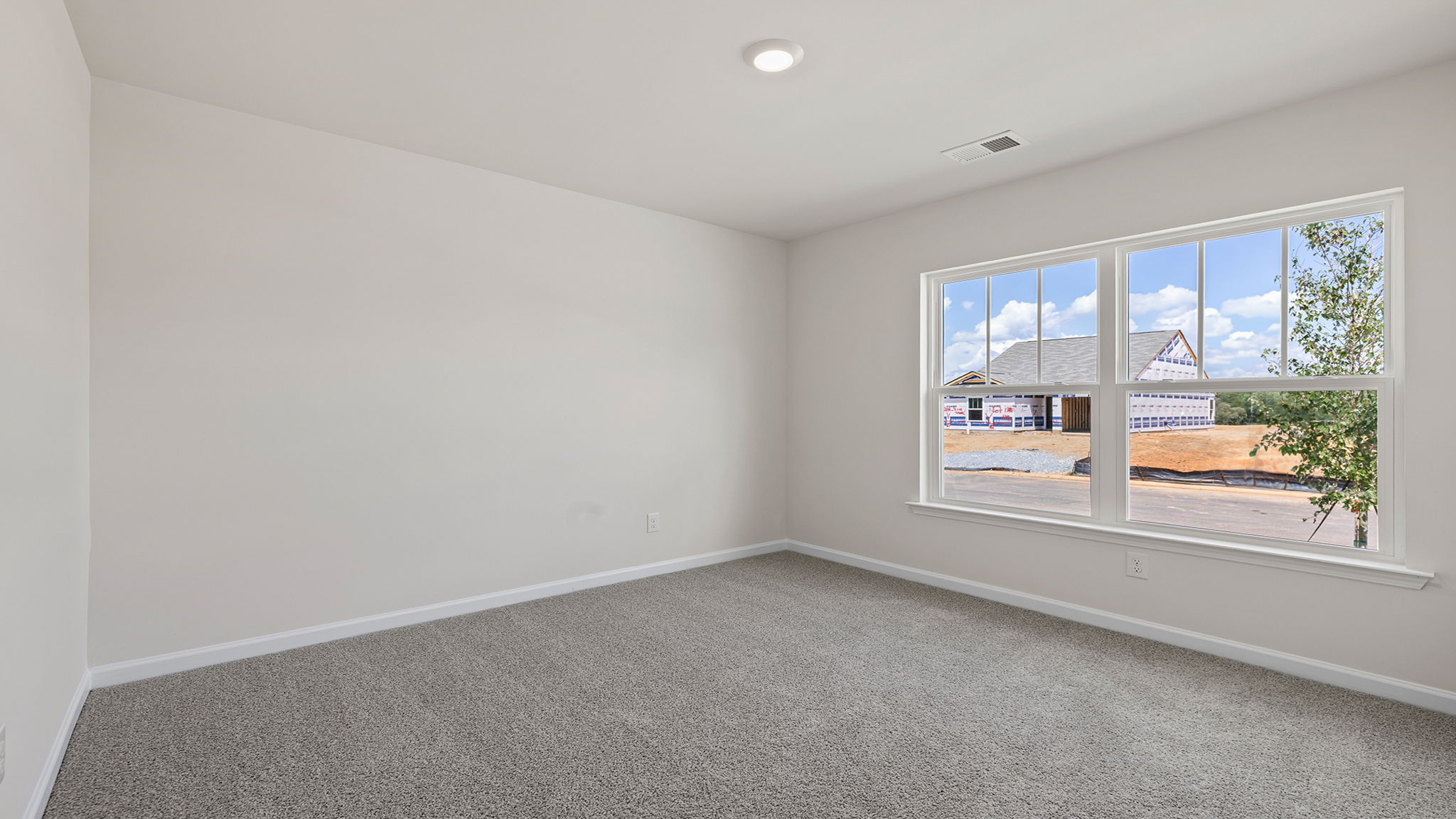 Bedroom with window and carpet.
