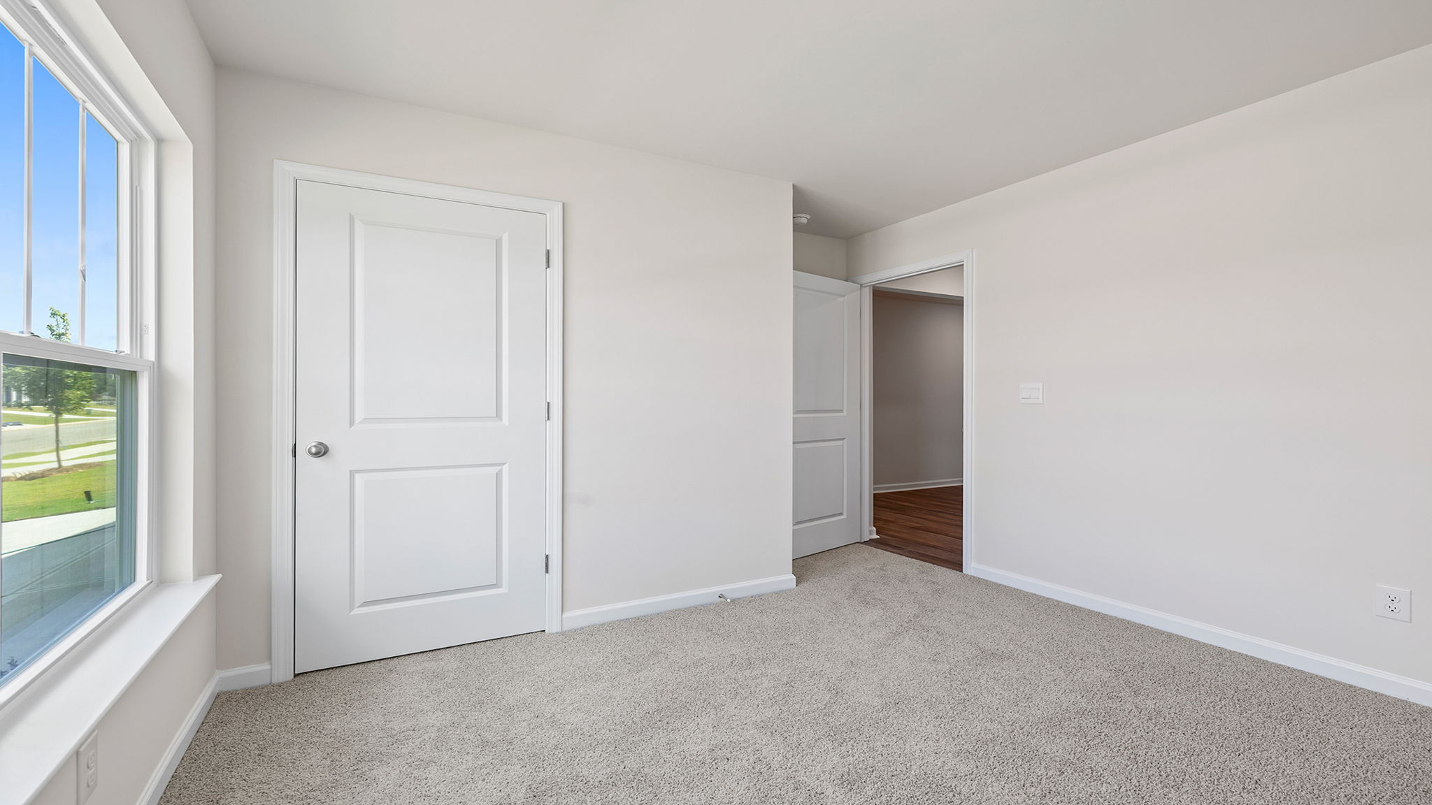Bedroom with window and carpet.