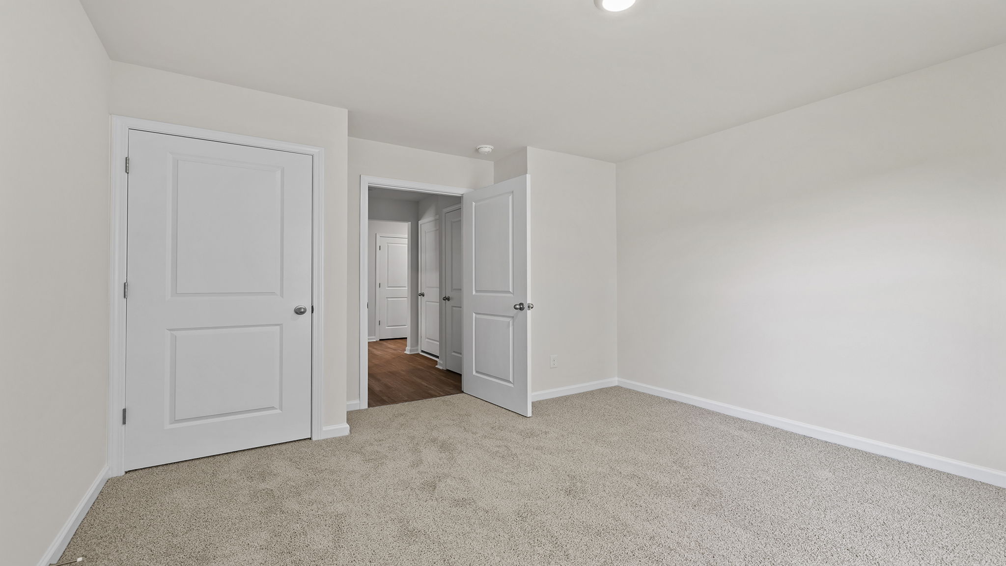 Bedroom with window and carpet.