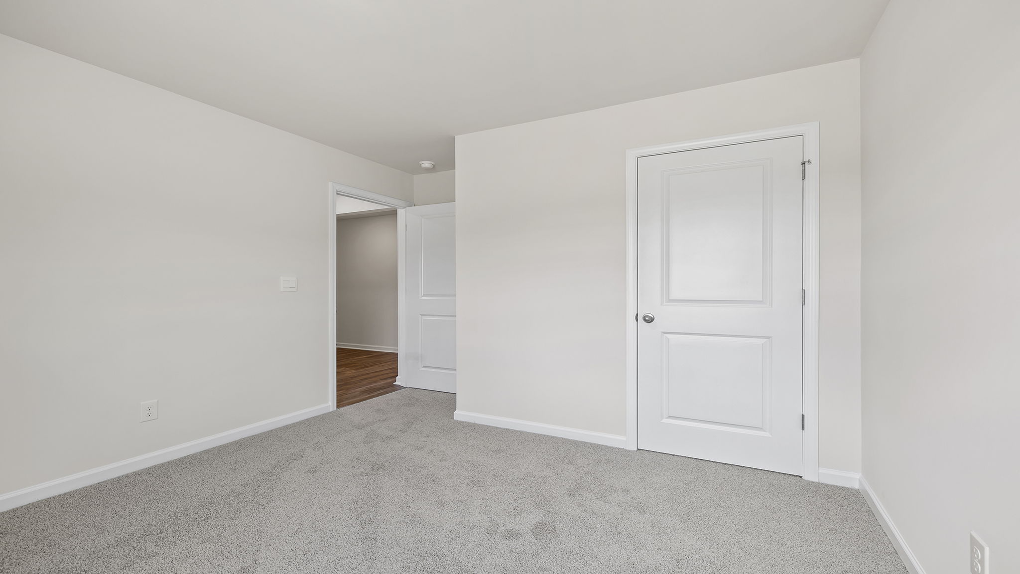 Bedroom with window and carpet.