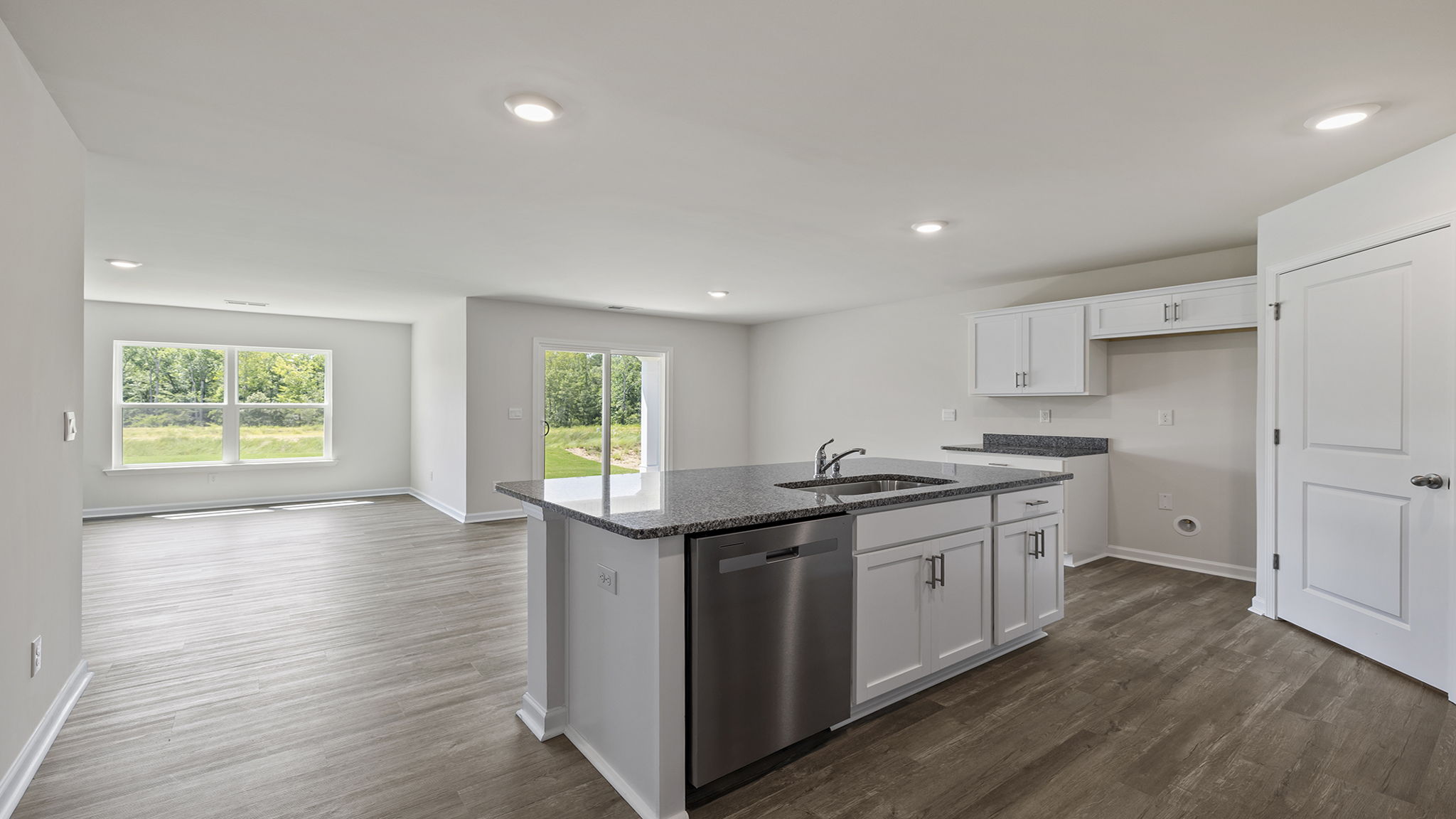 View of dining area from the kitchen and door to outside patio.