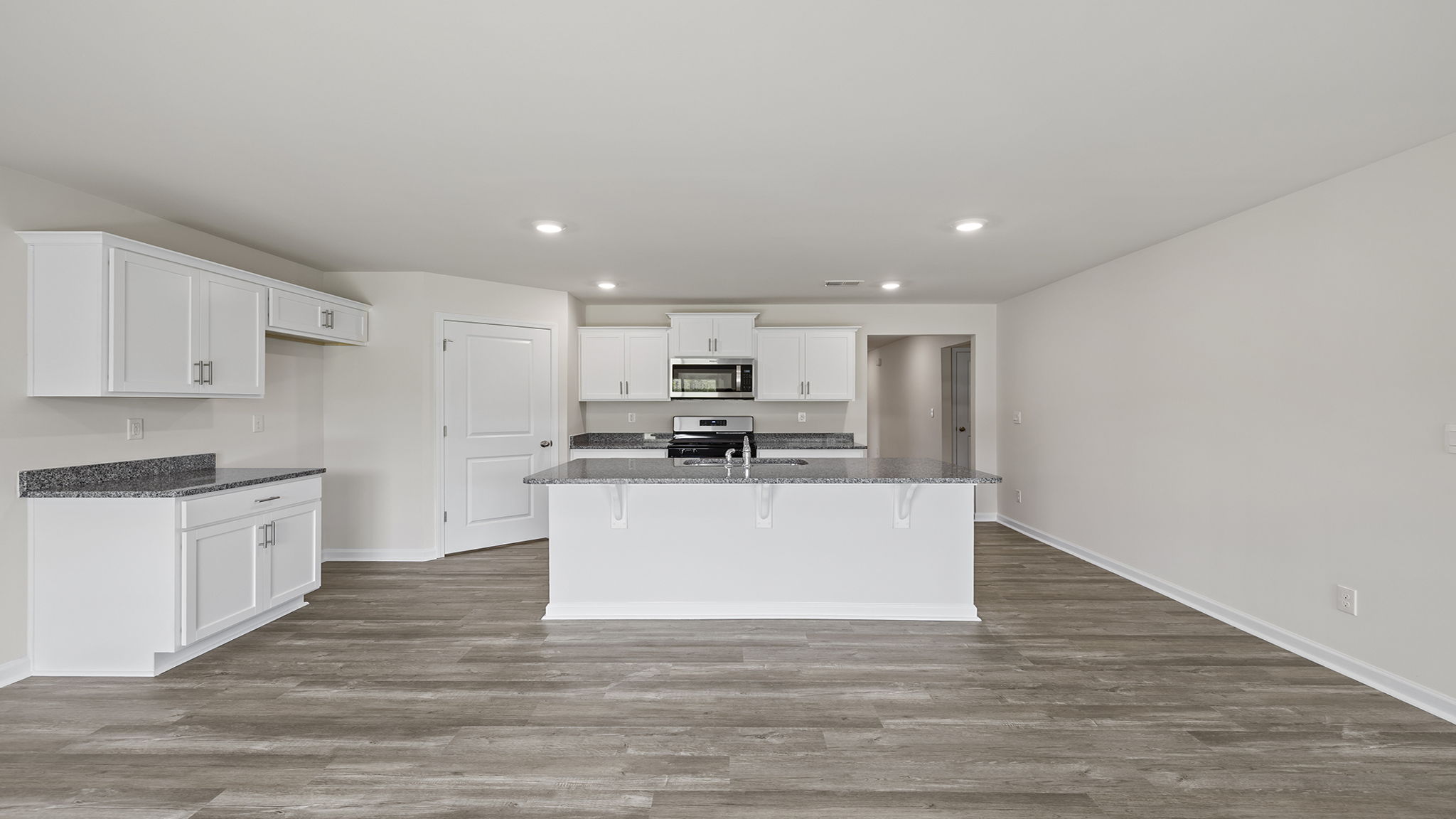 View of kitchen and hallway to entrance.