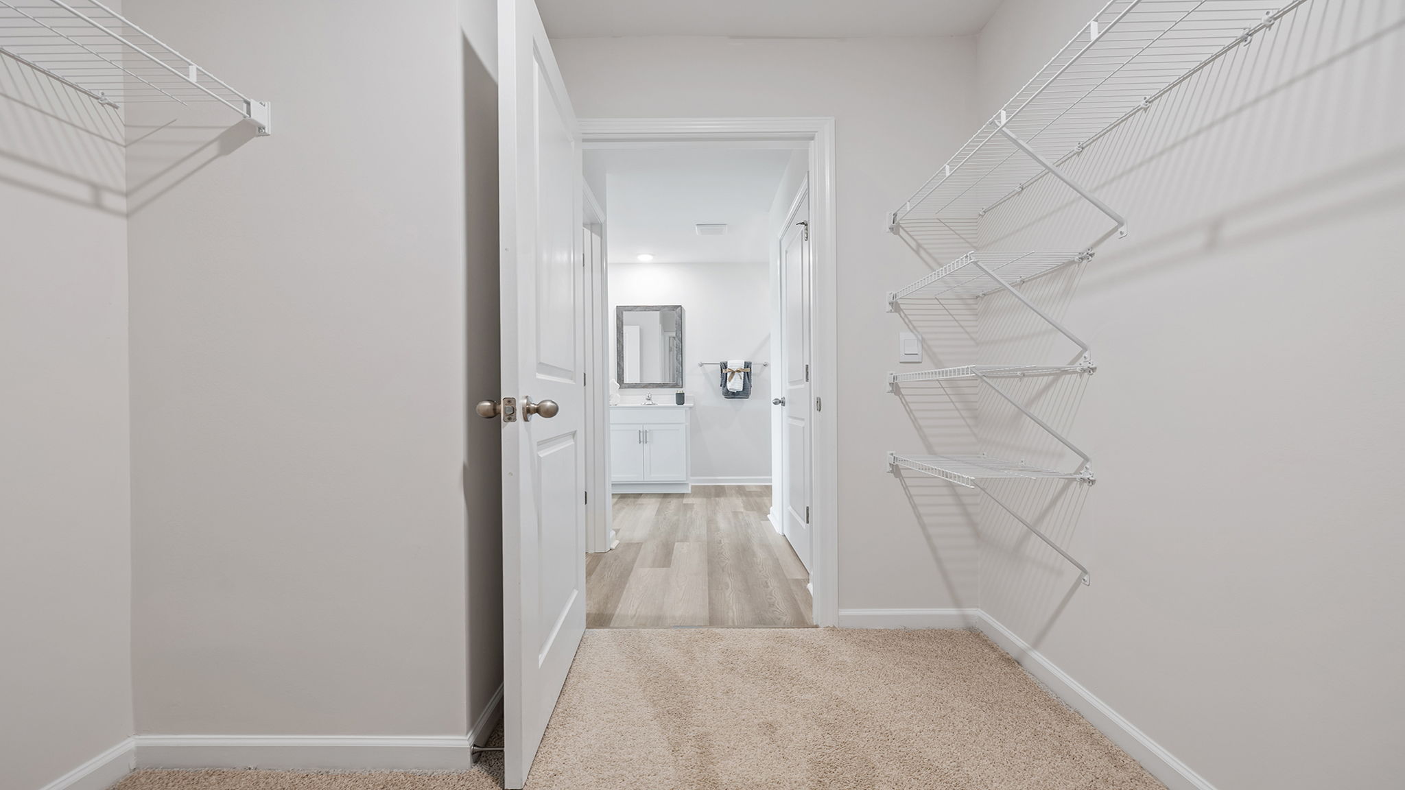Primary closet with shelf.