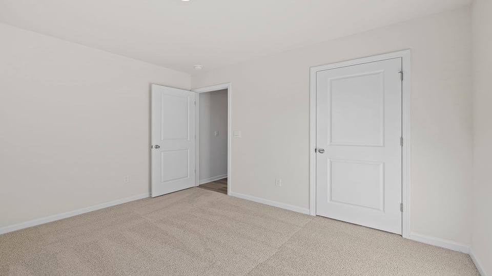 Bedroom with carpet and window.