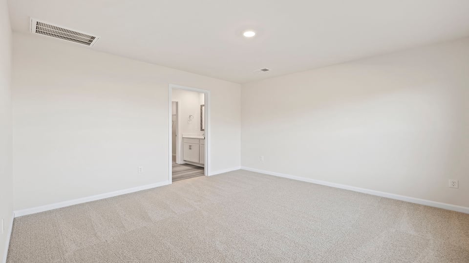 Bedroom with carpet and window.