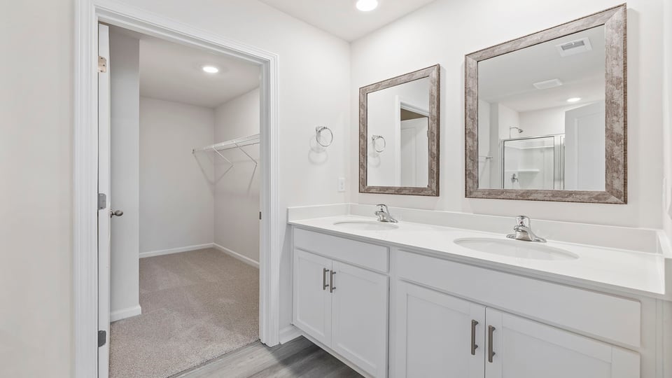 Bathroom with double vanity sink and closet.