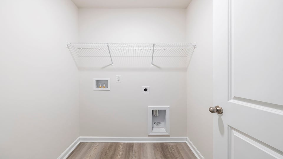Laundry room with hanging storage racks.