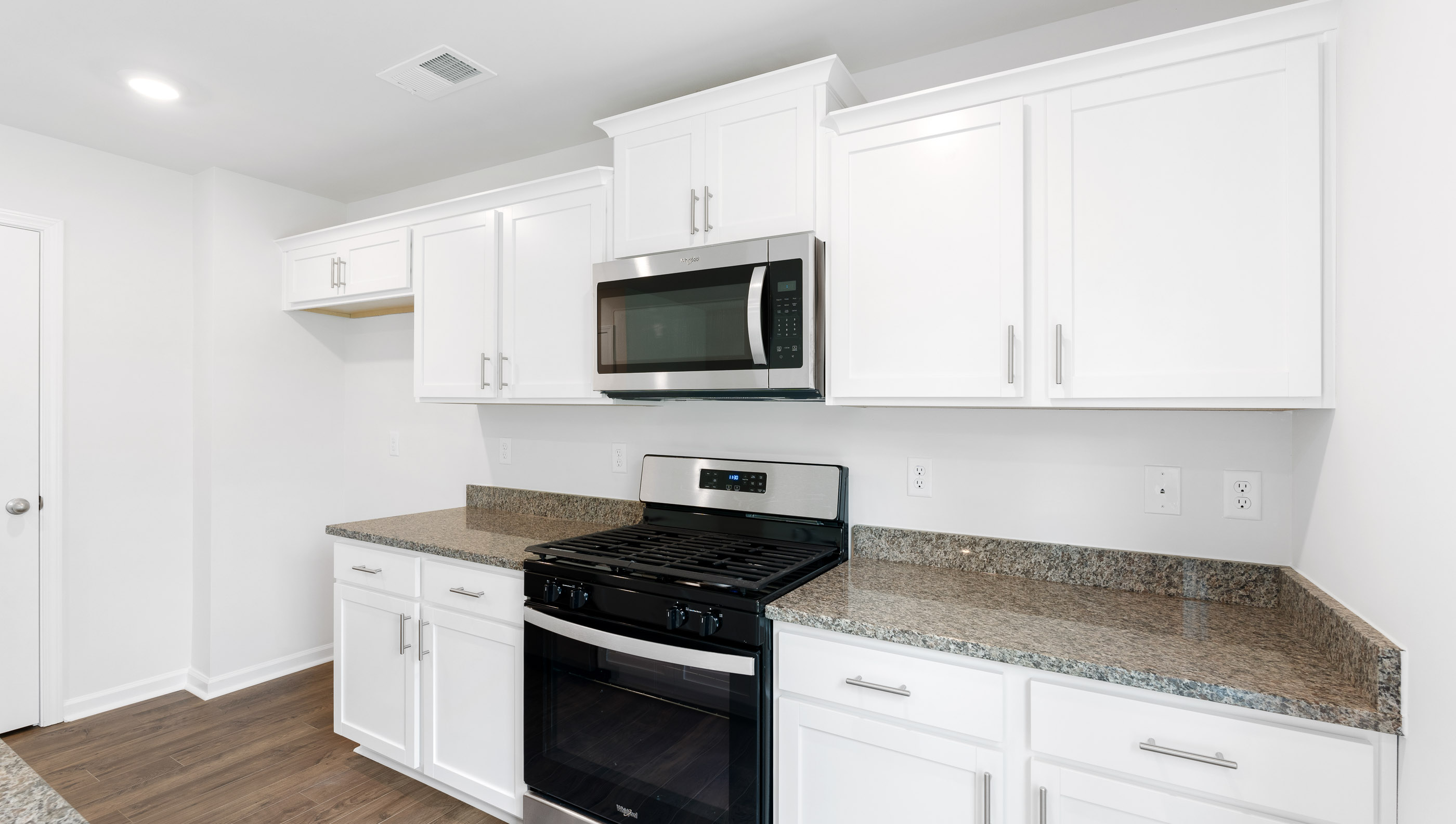 Kitchen and island with granite counter tops.