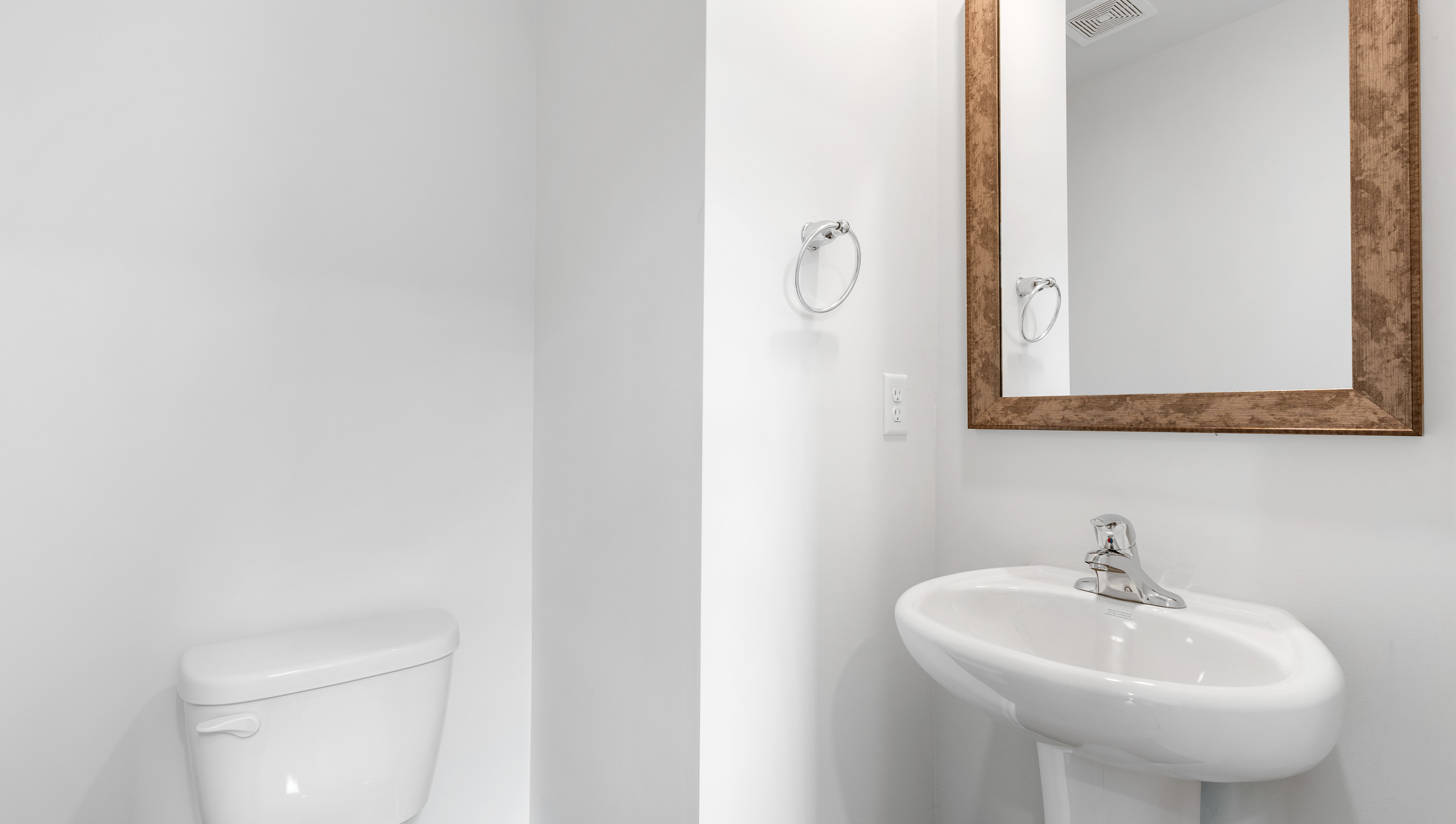 Half bathroom with mirror.