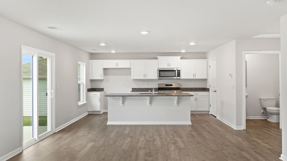 Kitchen with island and cabinets.