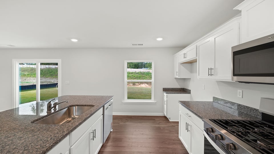 Kitchen with island and cabinets.
