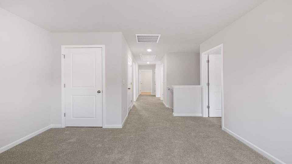 Loft area with carpet and windows.