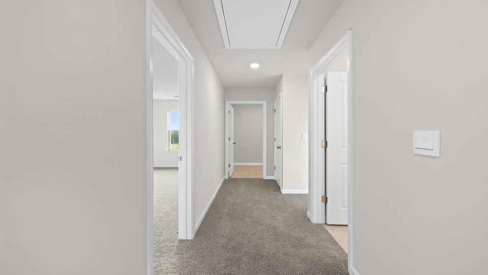 Loft area with carpet and windows.