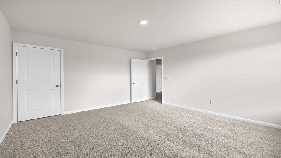 Bedroom with carpet and window.