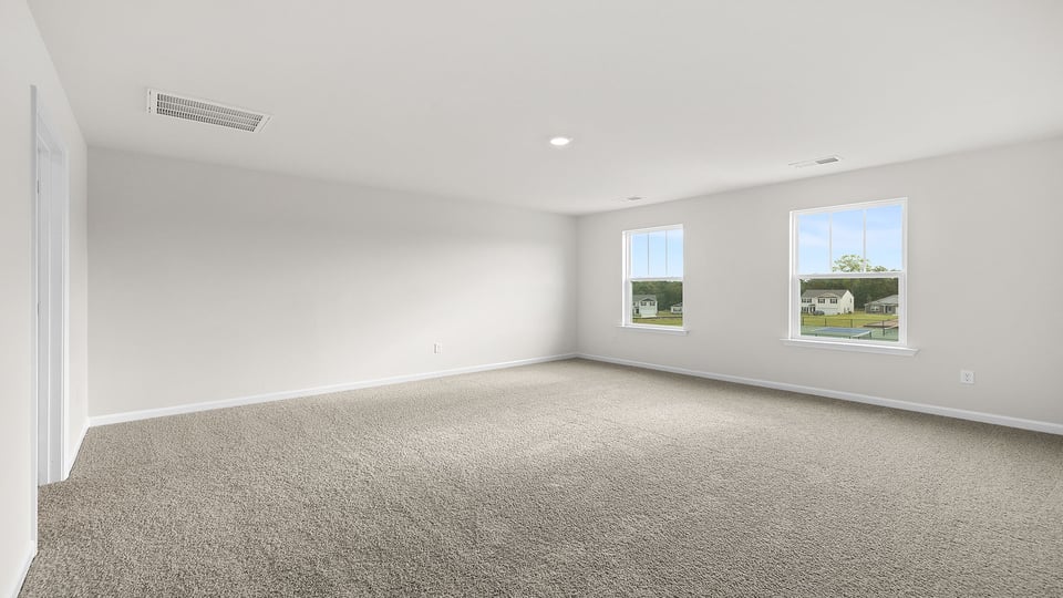 Bedroom with carpet and window.