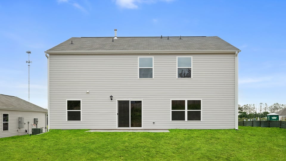 Back exterior with large backyard.