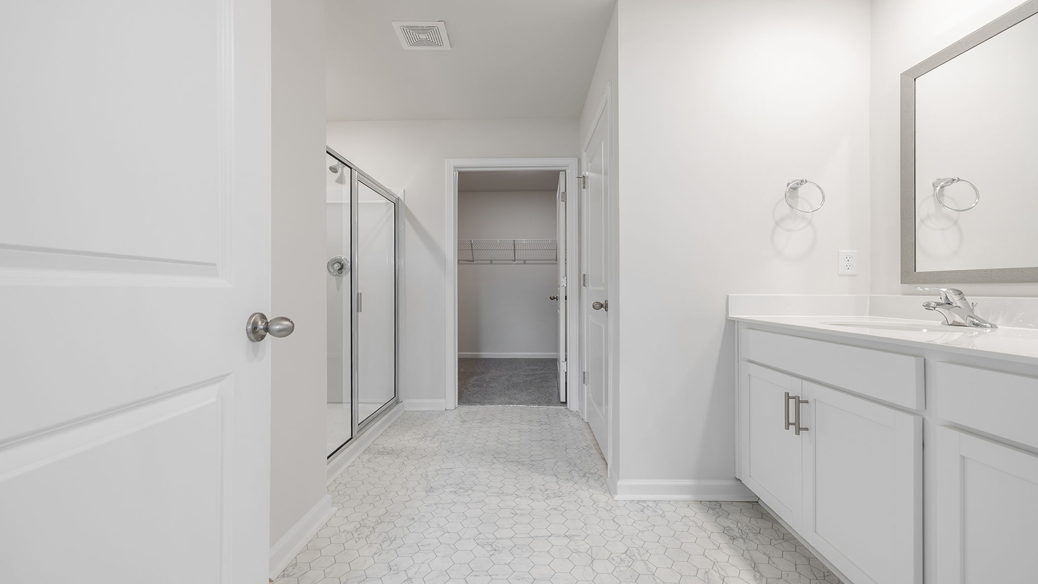 Primary bathroom with dual sink vanity.